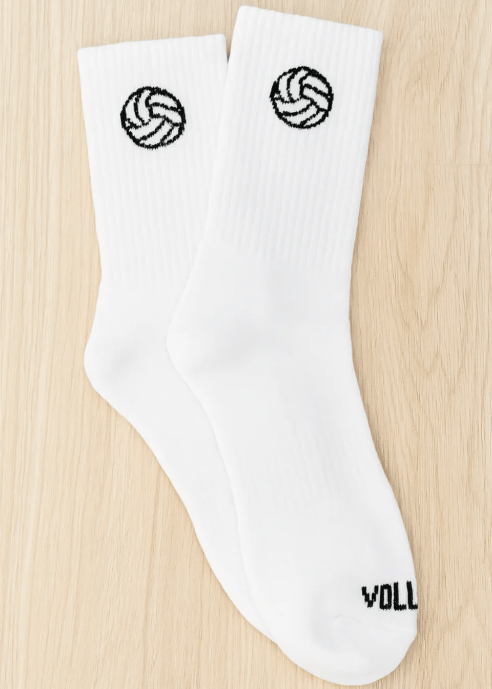White socks with volleyball designs on a wooden surface